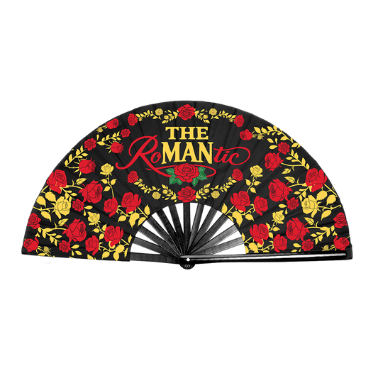 A folding hand fan with a black background printed with red and yellow roses, green leaves, and the text 'The Romantic' in red and yellow. The fan is shown partially open.